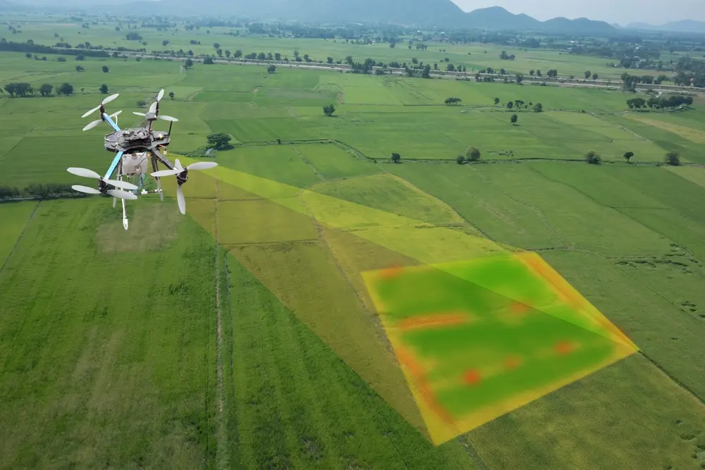 Droid drone showing radar unit and spray nozzles in a field setting