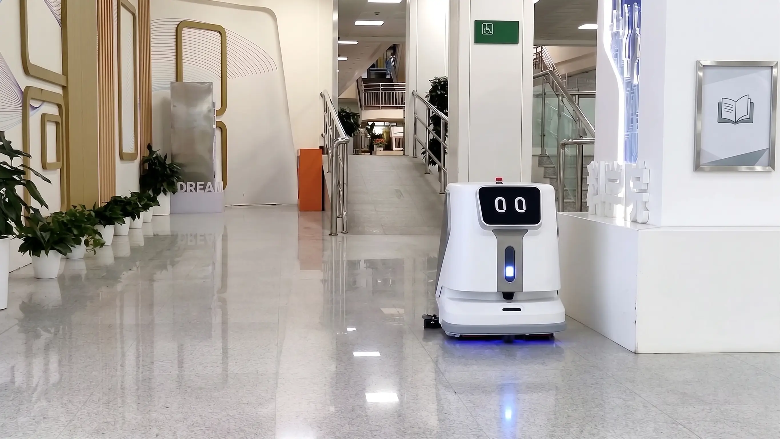 Droid cleaning robot working a dining room aisle after close