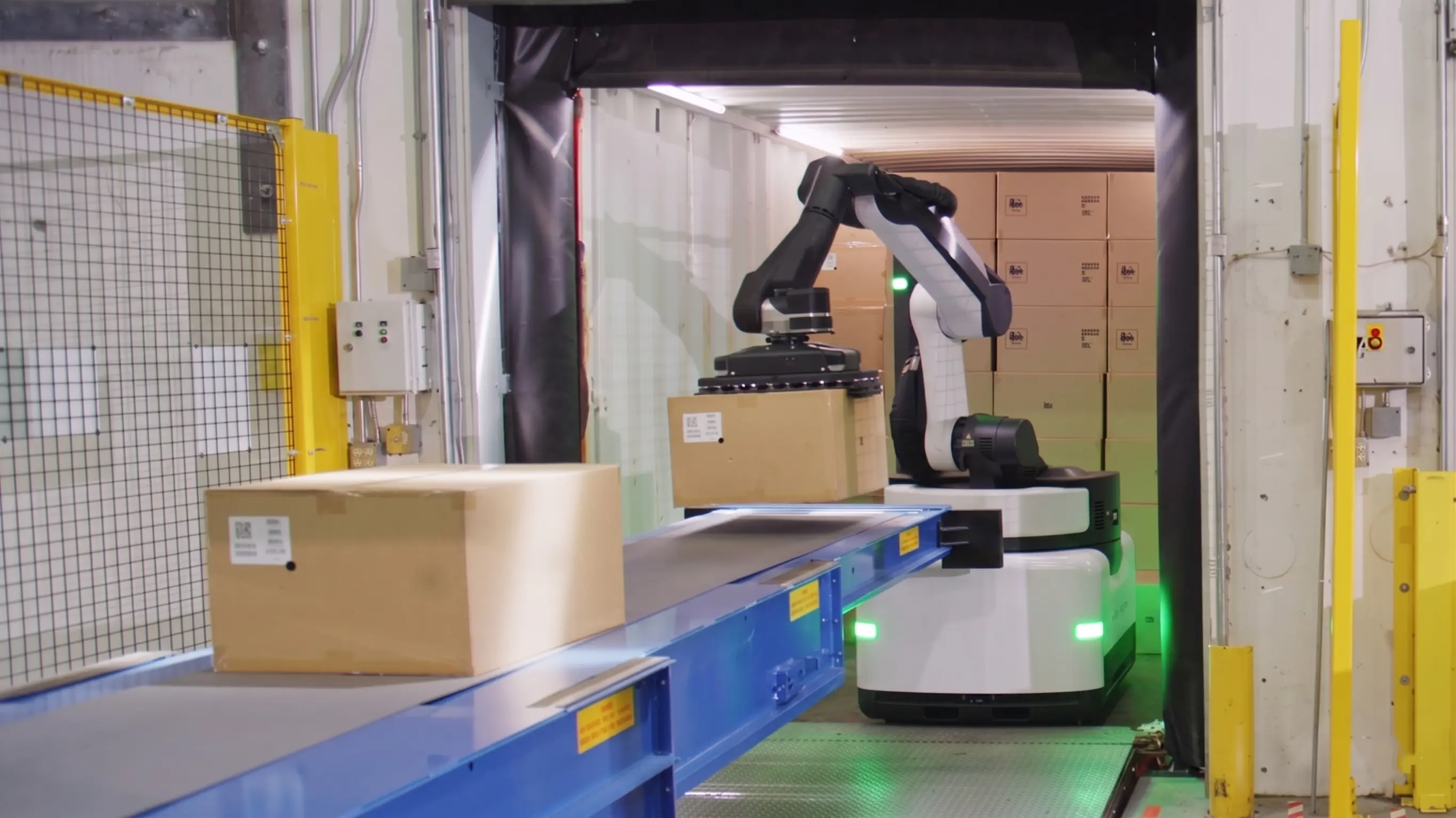 Droid tugger AMR pulling a loaded cart train down a warehouse aisle