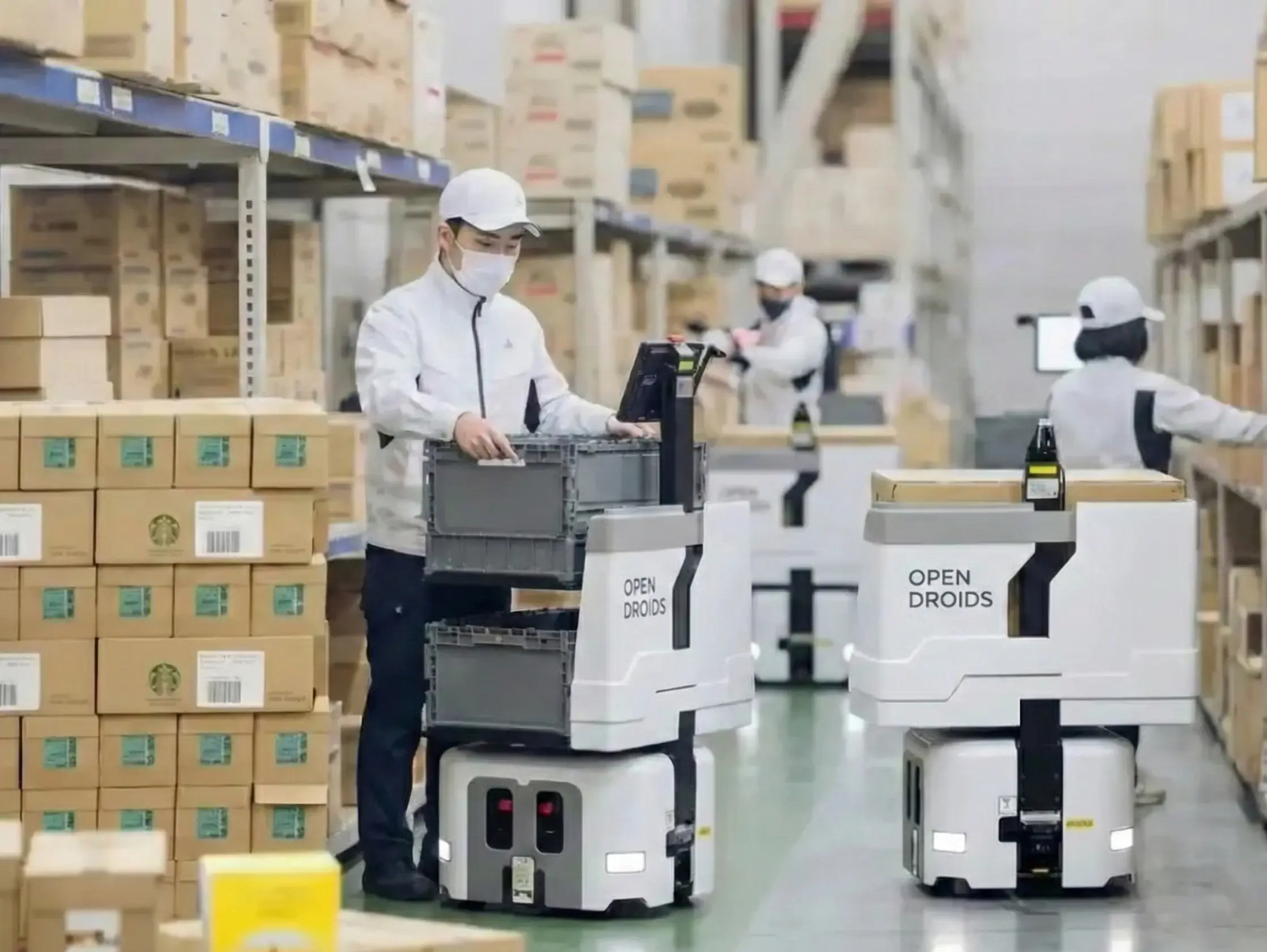 Droid AMR units operating in an active distribution warehouse